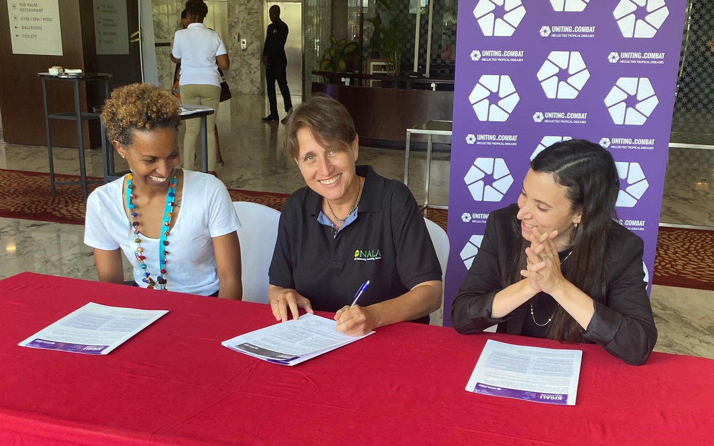 Three representatives from the NALA Foundation sign the Kigali Declaration on NTDs