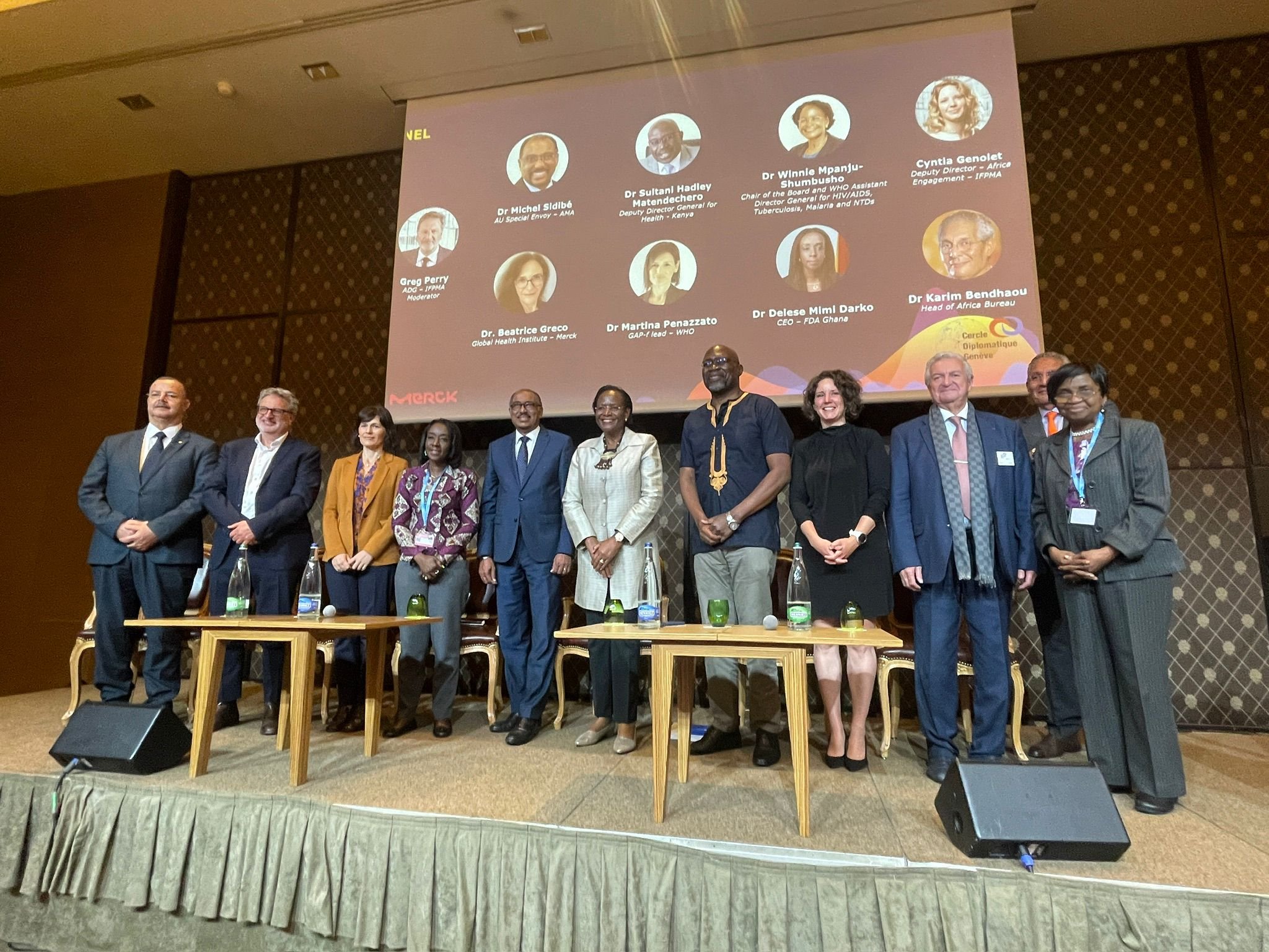 Dr Winnie Mpanju-Shumbusho stands on stage at Merck World Health Assembly side event